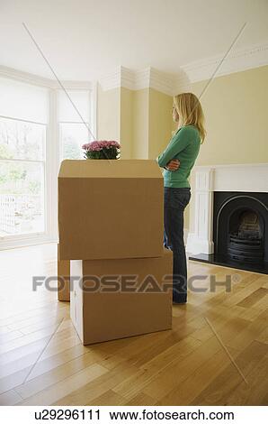 Woman with cardboard boxes in new home View Large Photo Image Stock Image - Woman with cardboard boxes in new home. Fotosearch