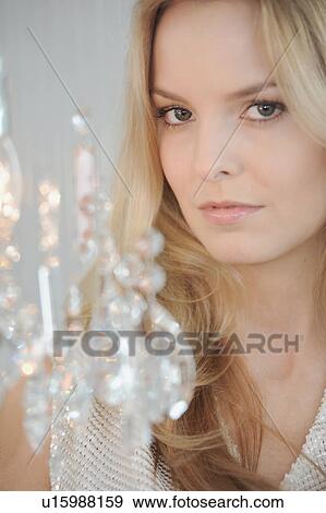 Stock Photo - Woman with crystal chandelier. Fotosearch