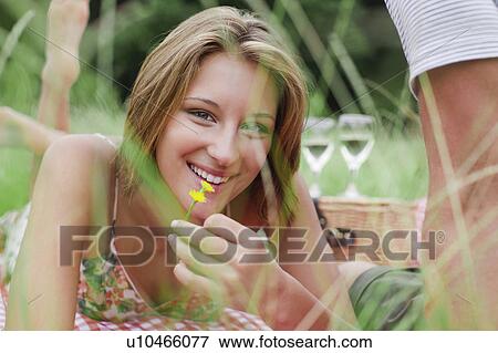 Woman with flower on picnic blanket View Large Photo Image Stock Photo - Woman with flower on picnic blanket. Fotosearch