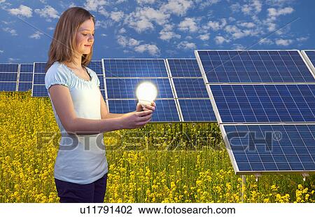 Woman with lightbulb and solar panels View Large Photo Image Stock Image - Woman with lightbulb and solar panels. Fotosearch