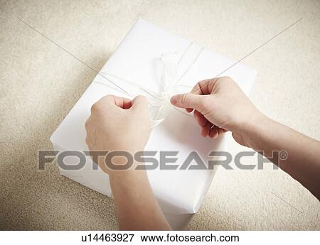 Stock Photo - Woman wrapping a gift. Fotosearch