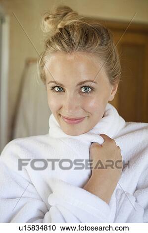 Woman wrapping herself in bathrobe View Large Photo Image Stock Image - Woman wrapping herself in bathrobe. Fotosearch