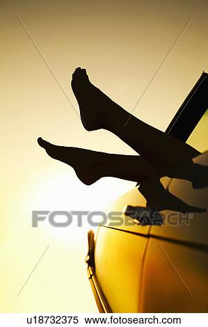 Stock Photography - Woman’s feet sticking out of car window. Fotosearch