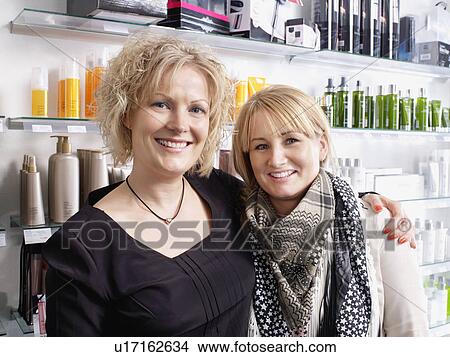Women embracing in hair salon View Large Photo Image Picture - Women embracing in hair salon. Fotosearch