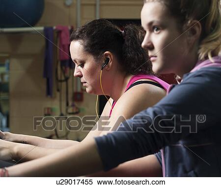 Stock Photography - Women exercising in gym. Fotosearch