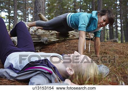 Women exercising together in forest View Large Photo Image Picture - Women exercising together in forest. Fotosearch