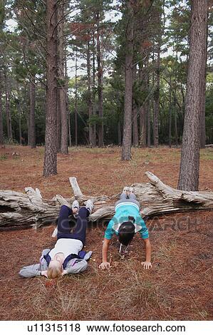 Women exercising together in forest View Large Photo Image Stock Photo - Women exercising together in forest. Fotosearch