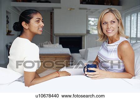 Women having coffee in living room View Large Photo Image Stock Image - Women having coffee in living room. Fotosearch