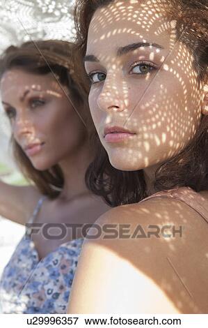 Women holding blanket over them View Large Photo Image Stock Photo - Women holding blanket over them. Fotosearch