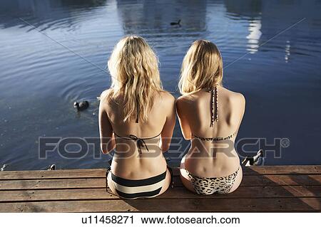 Women in bikinis sitting on deck View Large Photo Image Stock Image - Women in bikinis sitting on deck. Fotosearch
