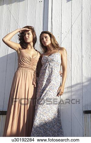 Women in dresses standing against door View Large Photo Image Picture - Women in dresses standing against door. Fotosearch