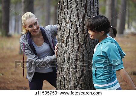 Women leaning on tree in forest View Large Photo Image Stock Photo - Women leaning on tree in forest. Fotosearch