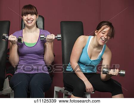 Women lifting weights together in gym View Large Photo Image Stock Photo - Women lifting weights together in gym. Fotosearch