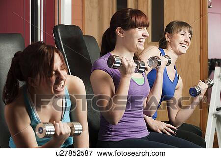 Women lifting weights together in gym View Large Photo Image Stock Photo - Women lifting weights together in gym. Fotosearch