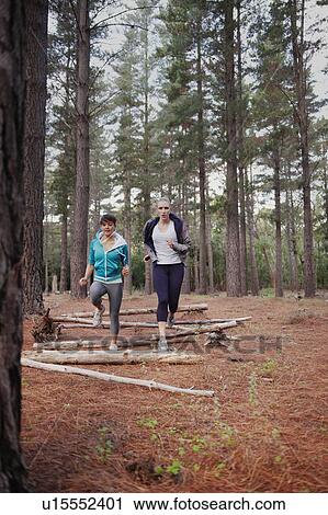 Women running in forest View Large Photo Image Stock Image - Women running in forest. Fotosearch
