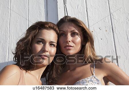 Women standing against door View Large Photo Image Stock Image - Women standing against door. Fotosearch