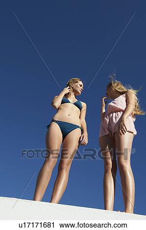Women standing on wall outdoors View Large Photo Image Stock Image - Women standing on wall outdoors. Fotosearch