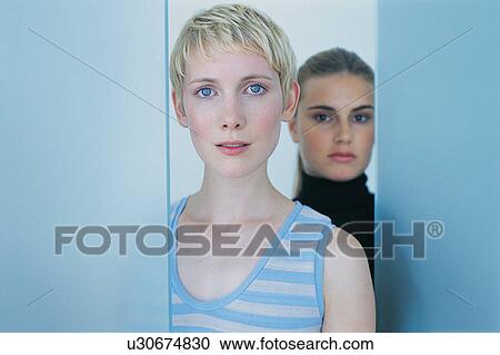 Women standing together in doorway View Large Photo Image Stock Image - Women standing together in doorway. Fotosearch