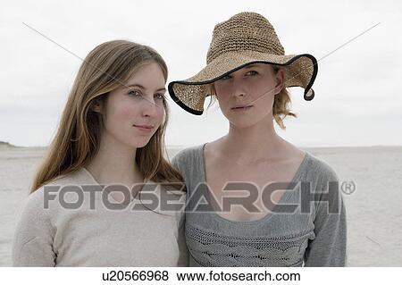 Stock Photo - Women standing together on beach. Fotosearch