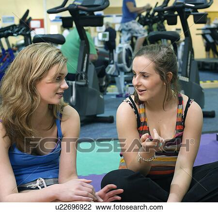 Women talking in gym View Large Photo Image Stock Image - Women talking in gym. Fotosearch