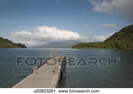 Stock Image - Wooden jetty over lake. Fotosearch