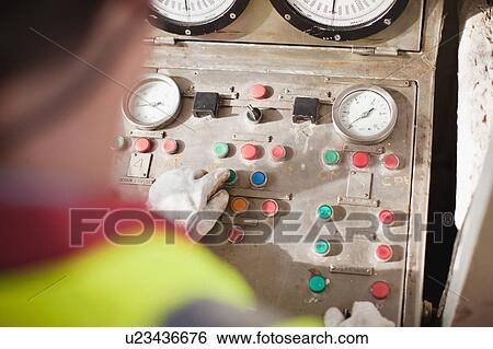 Worker at control panel of oil rig View Large Photo Image Stock Photograph - Worker at control panel of oil rig. Fotosearch