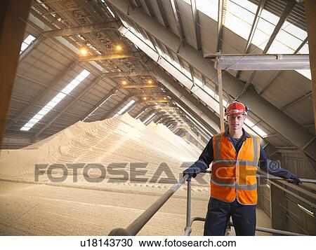 Stock Image - Worker at gypsum facility. Fotosearch