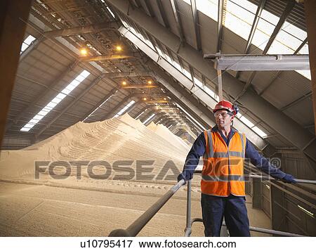 Stock Photo - Worker at gypsum facility. Fotosearch