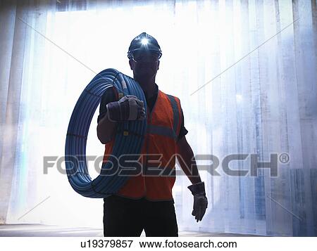 Worker carrying water pipes View Large Photo Image Stock Photo - Worker carrying water pipes. Fotosearch