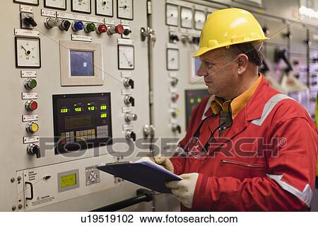 Worker checking machinery View Large Photo Image Stock Image - Worker checking machinery. Fotosearch