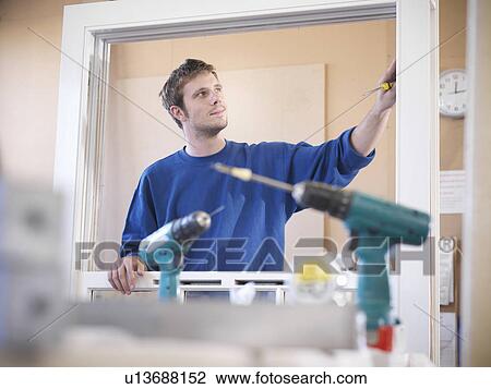 Worker examining window frame View Large Photo Image Stock Image - Worker examining window frame. Fotosearch