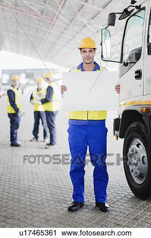 Worker holding blank card by truck View Large Photo Image Stock Image - Worker holding blank card by truck. Fotosearch