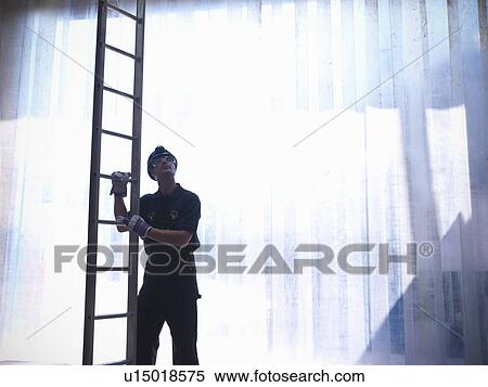 Worker holding ladder View Large Photo Image Stock Photography - Worker holding ladder. Fotosearch