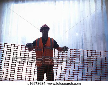 Worker holding plastic mesh View Large Photo Image Picture - Worker holding plastic mesh. Fotosearch