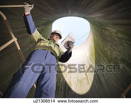 Worker in cooling tower of power station View Large Photo Image Picture - Worker in cooling tower of power station. Fotosearch