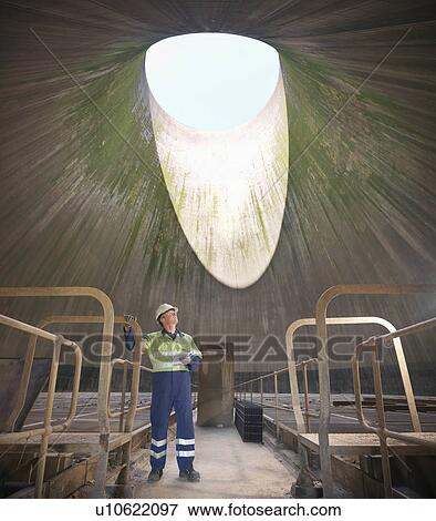 Worker in cooling tower of power station View Large Photo Image Stock Photo - Worker in cooling tower of power station. Fotosearch