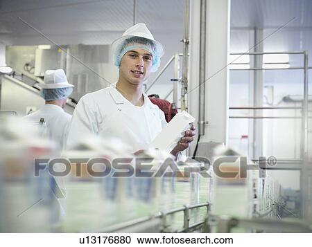 Worker inspecting goat's milk in dairy View Large Photo Image Stock Image - Worker inspecting goat's milk in dairy. Fotosearch