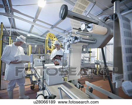 Worker packing boxes in dairy View Large Photo Image Stock Photo - Worker packing boxes in dairy. Fotosearch
