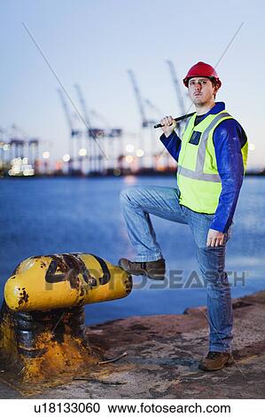 Worker standing at anchor in shipyard View Large Photo Image Stock Image - Worker standing at anchor in shipyard. Fotosearch