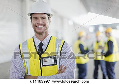 Worker standing in warehouse View Large Photo Image Stock Photo - Worker standing in warehouse. Fotosearch