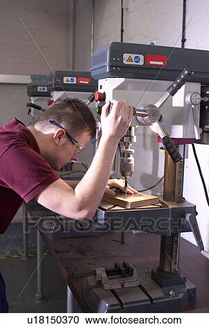 Worker using drill in factory View Large Photo Image Stock Image - Worker using drill in factory. Fotosearch