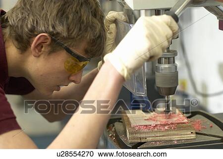 Worker using drill in factory View Large Photo Image Stock Image - Worker using drill in factory. Fotosearch