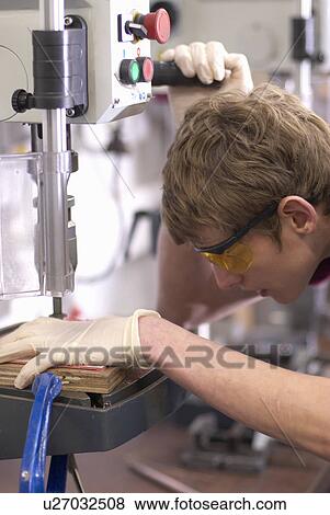Worker using drill in factory View Large Photo Image Stock Photo - Worker using drill in factory. Fotosearch