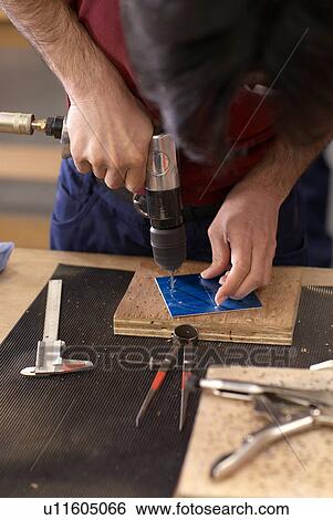 Worker using drill in factory View Large Photo Image Stock Photograph - Worker using drill in factory. Fotosearch