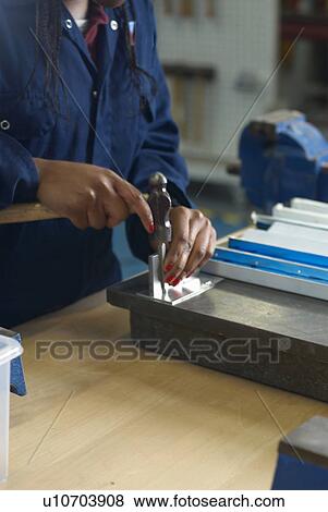 Worker using hammer in factory View Large Photo Image Stock Photo - Worker using hammer in factory. Fotosearch