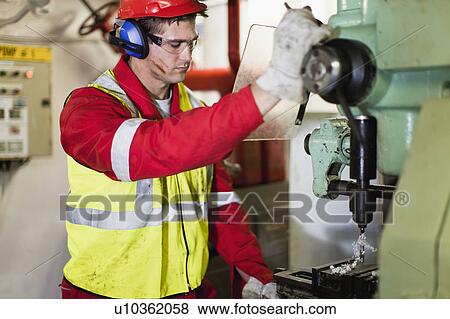 Worker using machinery on oil rig View Large Photo Image Stock Photo - Worker using machinery on oil rig. Fotosearch