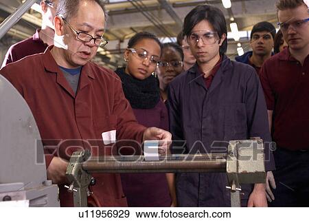 Worker using rollers in factory View Large Photo Image Stock Photo - Worker using rollers in factory. Fotosearch