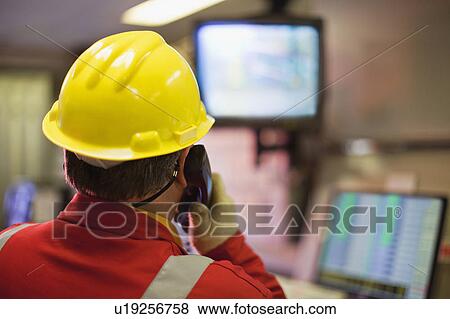 Worker watching security cameras View Large Photo Image Stock Photo - Worker watching security cameras. Fotosearch
