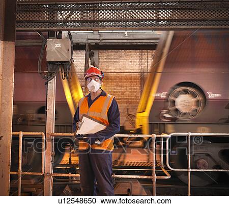 Worker wearing face mask in facility View Large Photo Image Stock Image - Worker wearing face mask in facility. Fotosearch