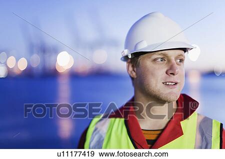 Worker wearing hard hat in shipyard View Large Photo Image Stock Photo - Worker wearing hard hat in shipyard. Fotosearch